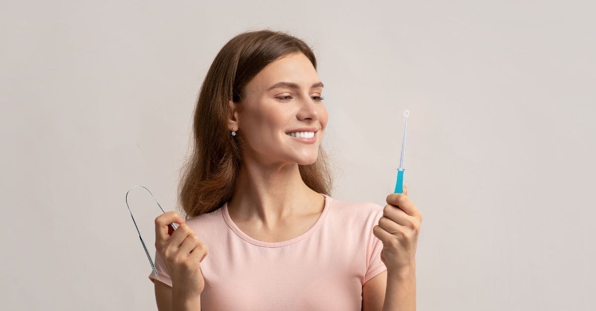 xr:d:DAF2OG06Yws:6,j:4649252175473847954,t:23120616 woman holding a tongue scraper and tonsil stone removal tools